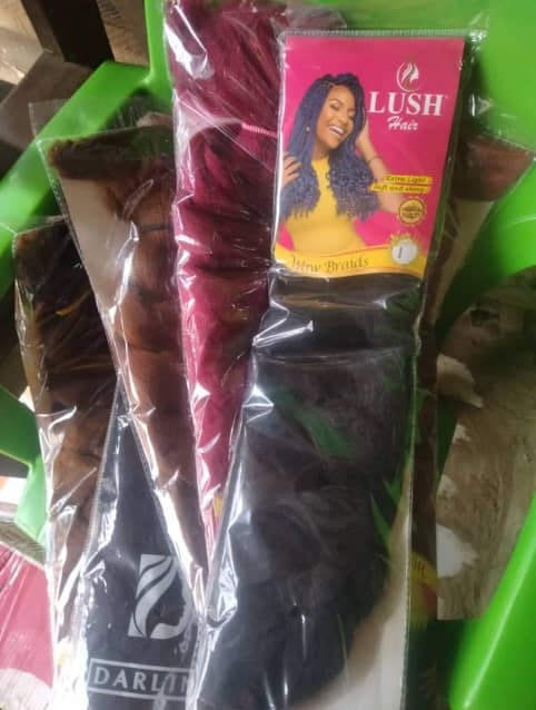 Packs of braiding hair extensions in burgundy, brown and black