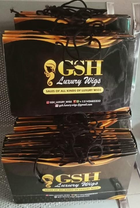 Stack of branded luxury wig gift bags ready for shipping